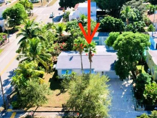 an aerial view of a house with a yard and garden