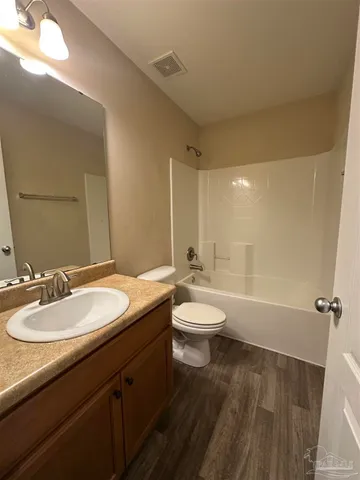 a bathroom with a double vanity sink toilet and shower