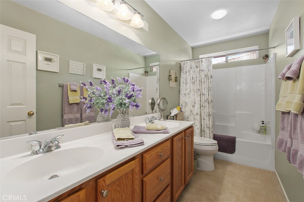 33370 Morning View Drive Temecula, CA 92592 - Photo 22 of 41 a bathroom with a double vanity sink toilet and shower