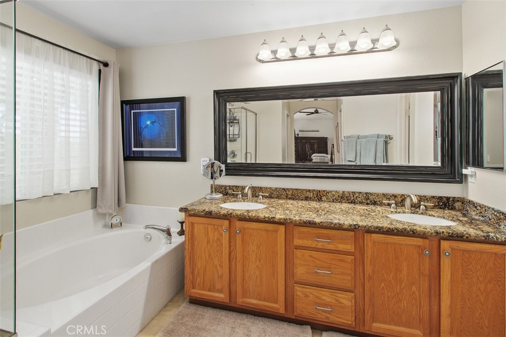 33370 Morning View Drive Temecula, CA 92592 - Photo 26 of 41 a bathroom with a granite countertop sink mirror and a bathtub