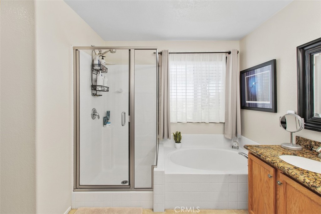 33370 Morning View Drive Temecula, CA 92592 - Photo 27 of 41 a bathroom with a granite countertop sink a mirror and a bathtub