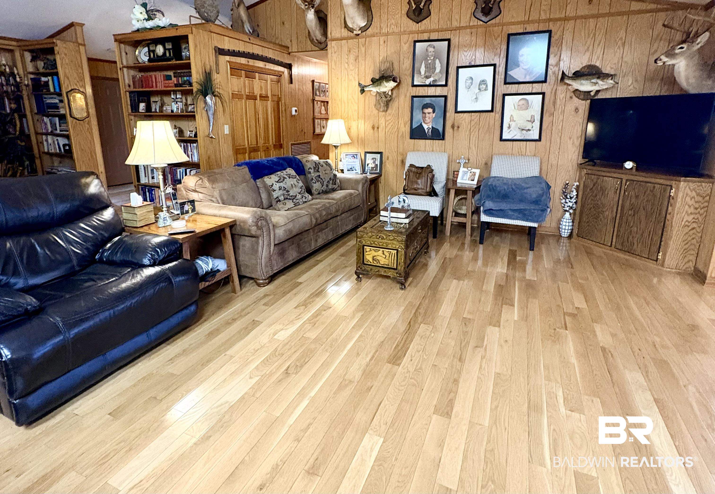 44 Ridge Road Castleberry, AL 36432 - Photo 13 of 33 Living room with light wood finished floors and wood walls