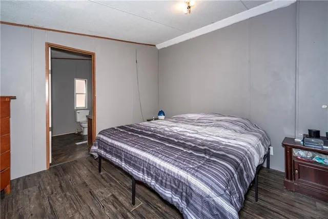 a bedroom with a bed and a dresser