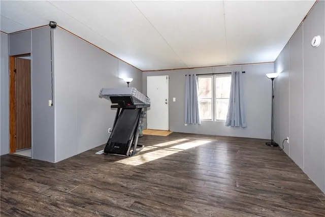 a living room with furniture a flat screen tv and a window