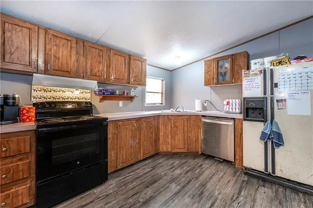 a kitchen with stainless steel appliances granite countertop a refrigerator and a stove top oven