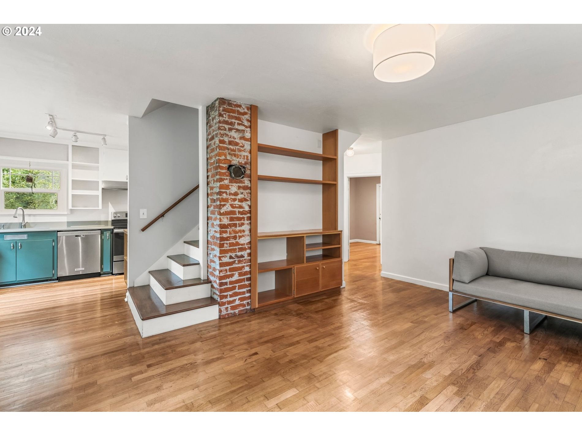 1343 West Broadway Eugene, OR 97402 - Photo 2 of 10 a living room with furniture and a wooden floor
