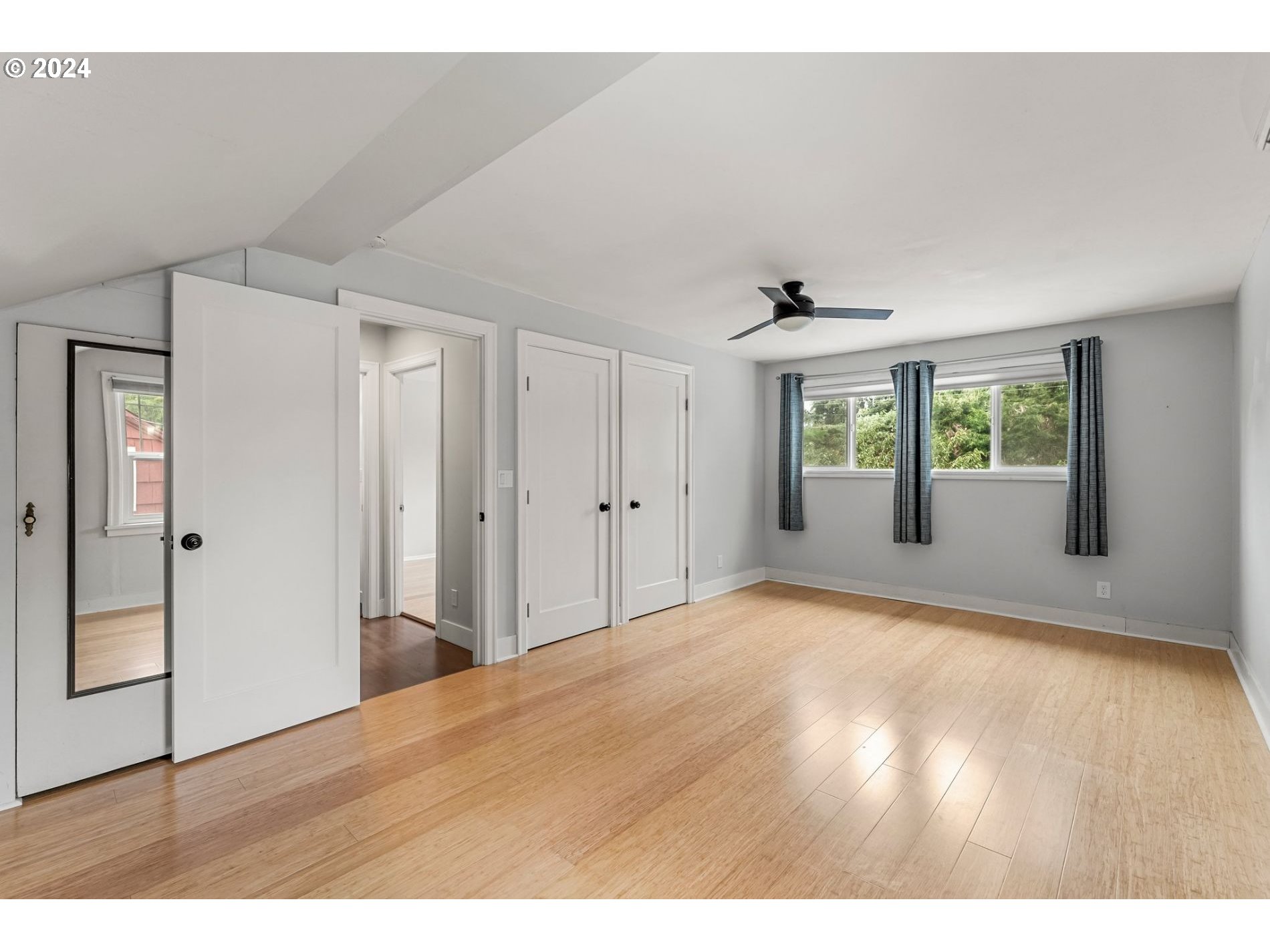 1343 West Broadway Eugene, OR 97402 - Photo 9 of 10 a view of an empty room with wooden floor and a window