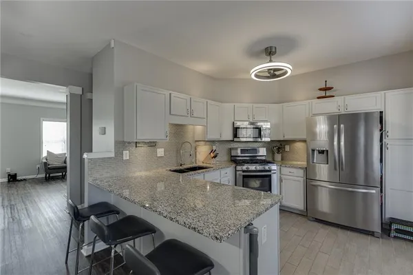 a kitchen with a center island and stainless steel appliances