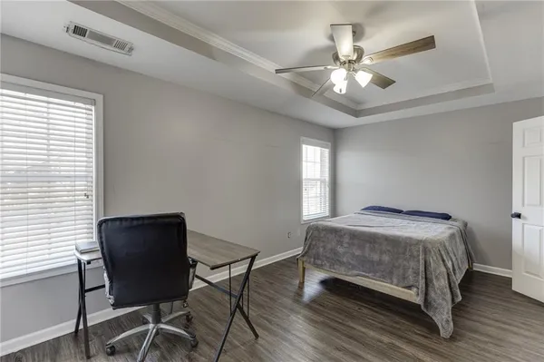 a bedroom with a bed window and a chair