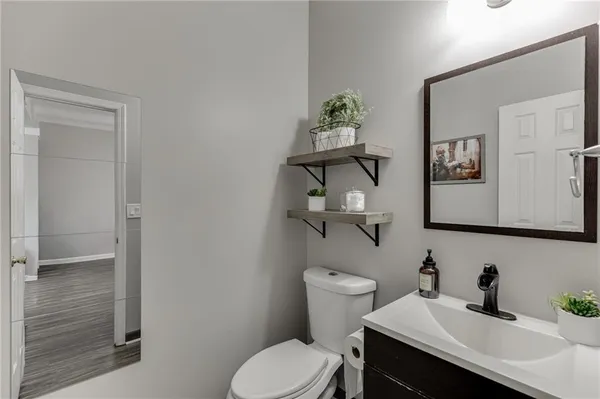 a bathroom with a toilet sink and mirror