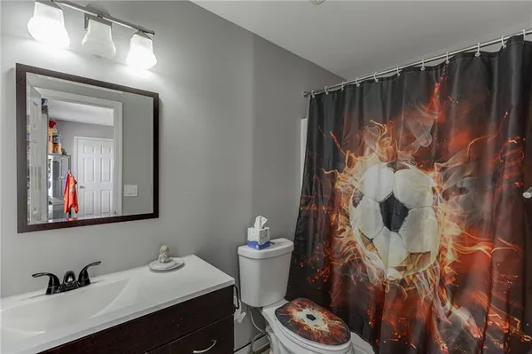 a bathroom with a sink vanity and toilet