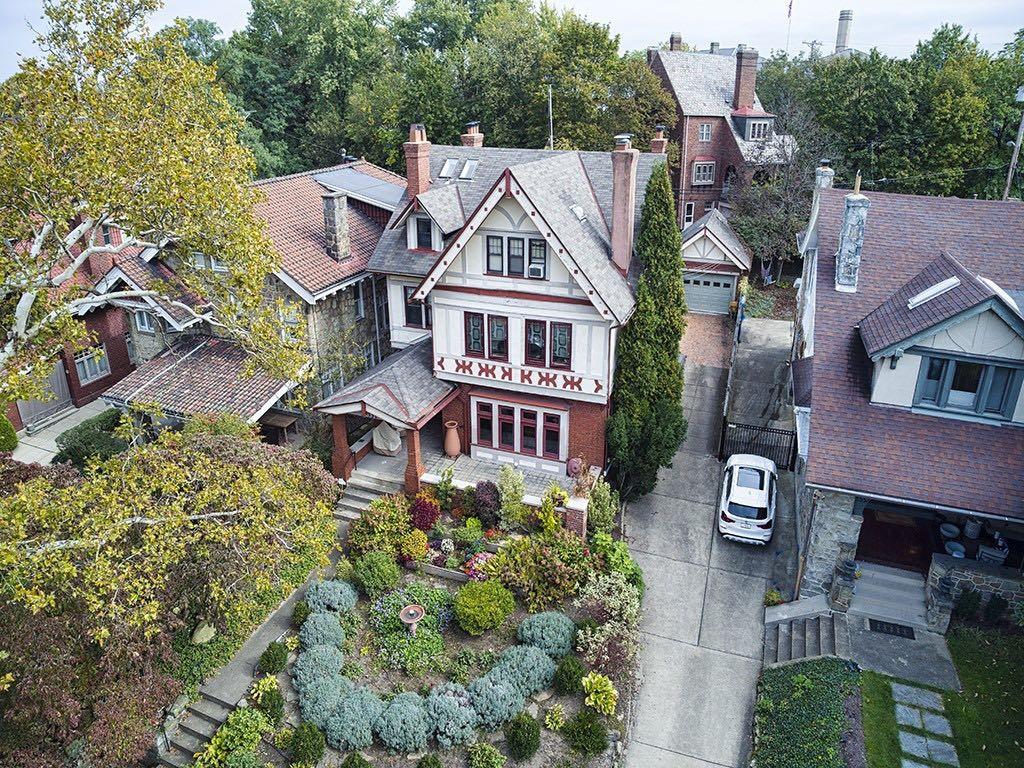 a aerial view of a house with a big yard and large trees