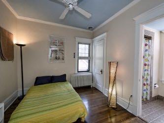 1331 Beechwood Boulevard Pittsburgh, PA 15217 - Photo 13 of 25 a bedroom with a bed wooden floor and window
