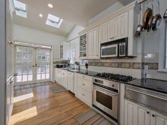 1331 Beechwood Boulevard Pittsburgh, PA 15217 - Photo 25 of 25 a kitchen with stainless steel appliances granite countertop a stove top oven a sink dishwasher a microwave oven and a refrigerator with wooden floor
