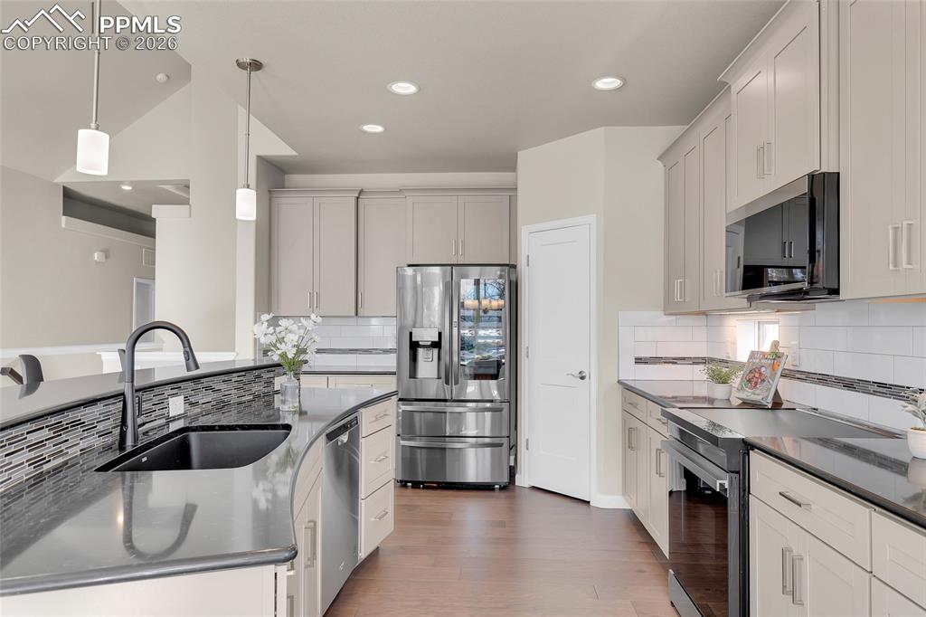 11830 Alydar Loop Colorado Springs, CO 80921 - Photo 11 of 37 a kitchen with a sink stainless steel appliances and cabinets