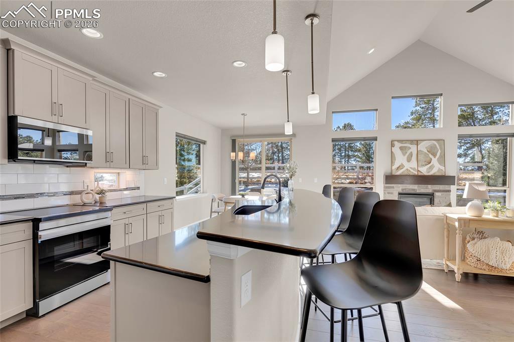 11830 Alydar Loop Colorado Springs, CO 80921 - Photo 13 of 37 a kitchen with granite countertop white cabinets and stainless steel appliances