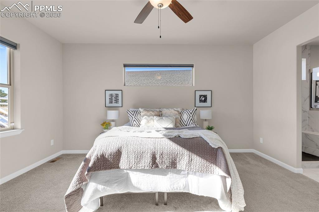 11830 Alydar Loop Colorado Springs, CO 80921 - Photo 17 of 37 a bed room with a bed and a chandelier