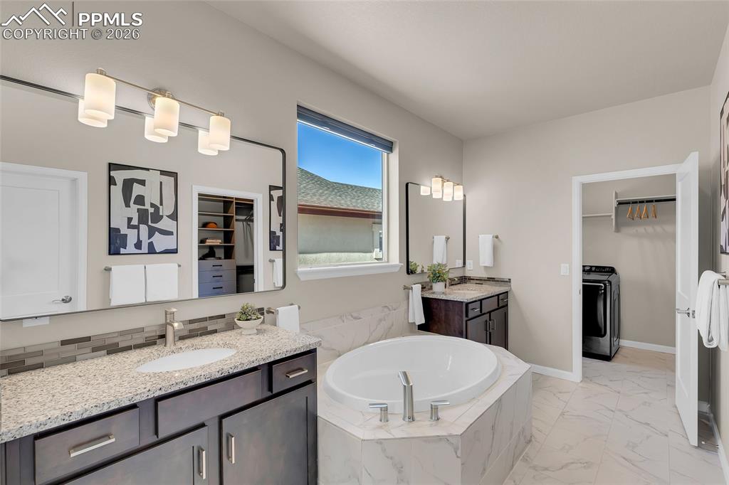 11830 Alydar Loop Colorado Springs, CO 80921 - Photo 19 of 37 a bathroom with a granite countertop sink and a mirror