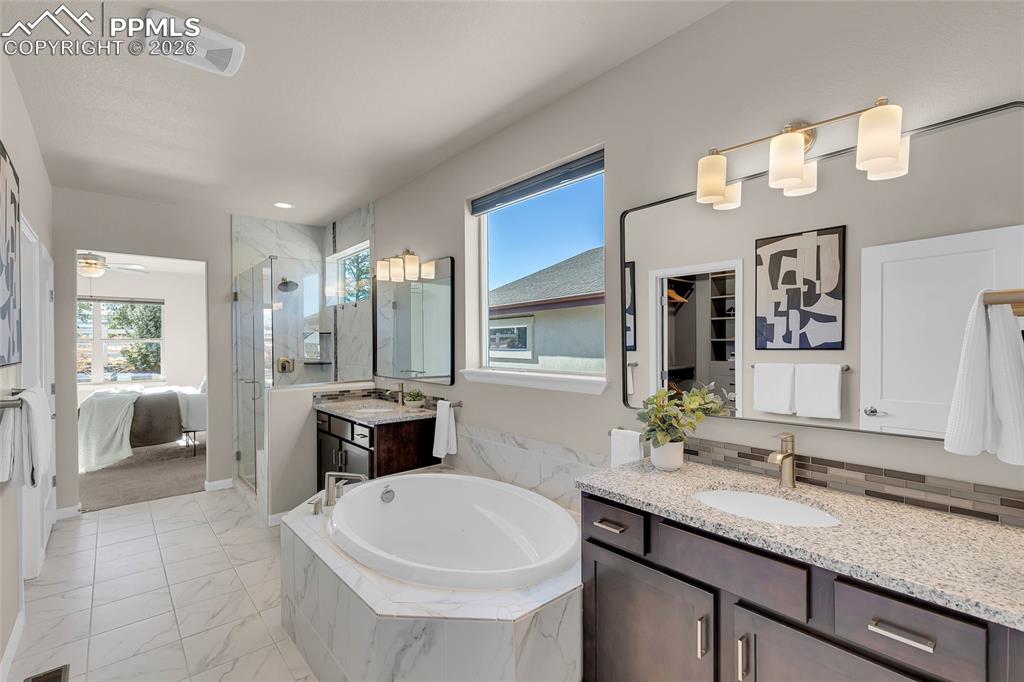 11830 Alydar Loop Colorado Springs, CO 80921 - Photo 20 of 37 a bathroom with a granite countertop sink and a mirror