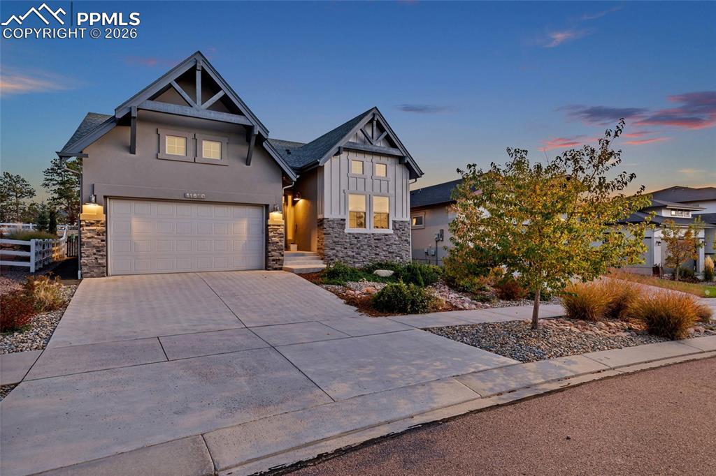 11830 Alydar Loop Colorado Springs, CO 80921 - Photo 2 of 37 a front view of a house with a yard and garage