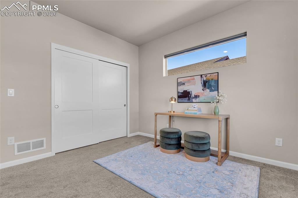 11830 Alydar Loop Colorado Springs, CO 80921 - Photo 24 of 37 a living room with furniture and a table
