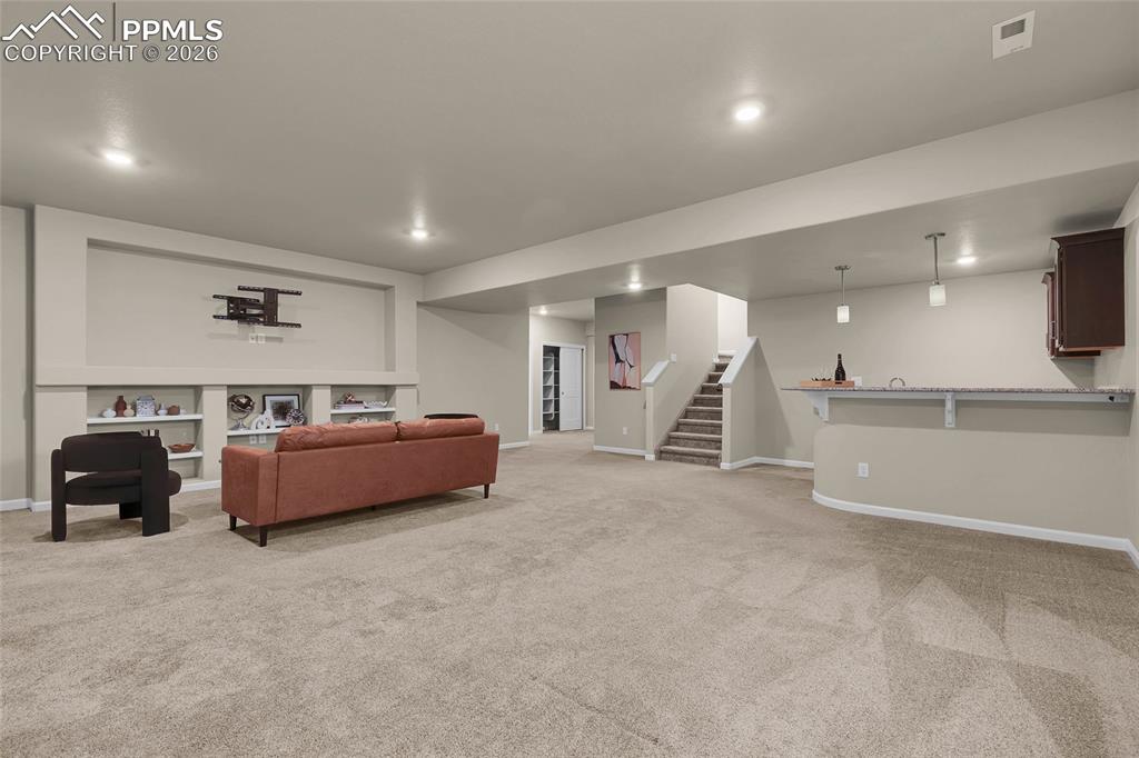 11830 Alydar Loop Colorado Springs, CO 80921 - Photo 27 of 37 a spacious bedroom with a bed and a cabinets