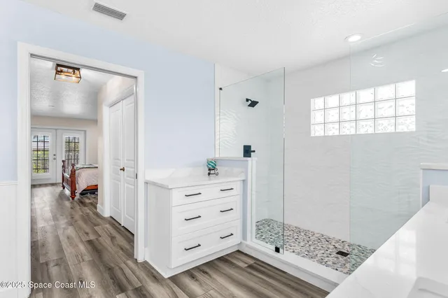 a view of walk in closet and bedroom