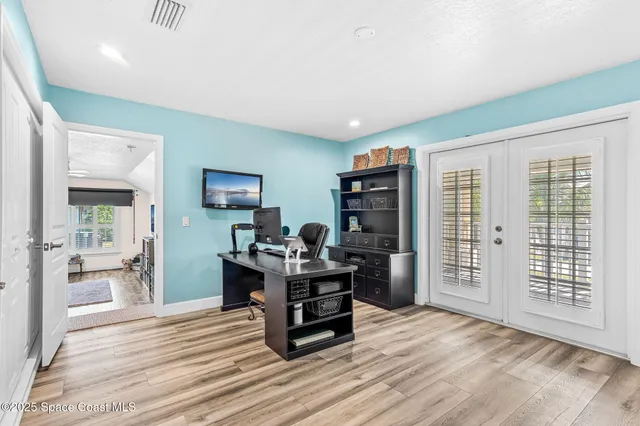a view of a livingroom with workspace and a window