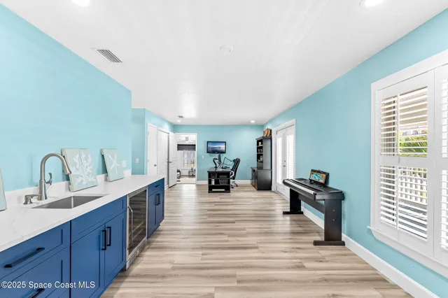 a large living room with stainless steel appliances granite countertop a couch and wooden floor