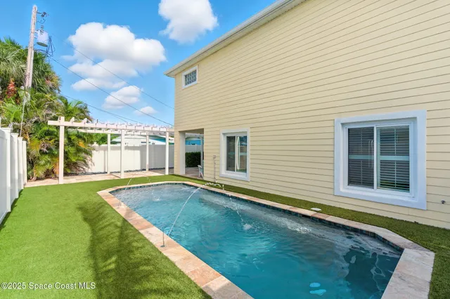 a view of a backyard with a swimming pool