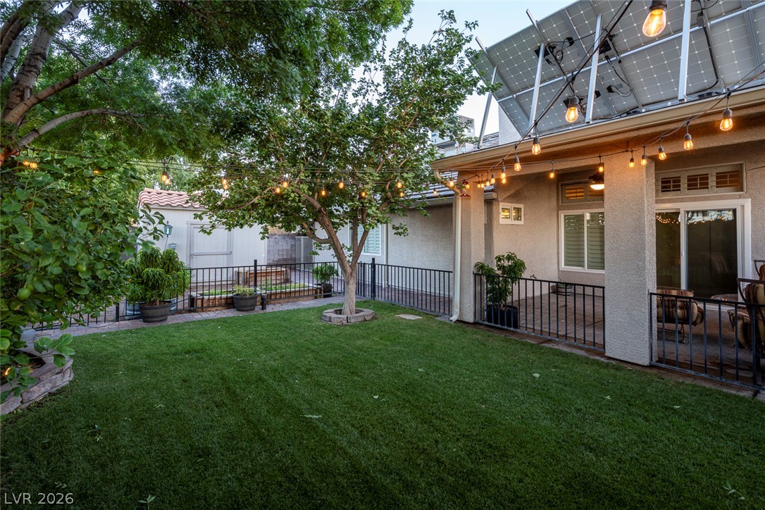 818 Manor Shores Road Henderson, NV 89002 - Photo 34 of 35 A private yard with mature trees offers a serene setting for outdoor enjoyment.