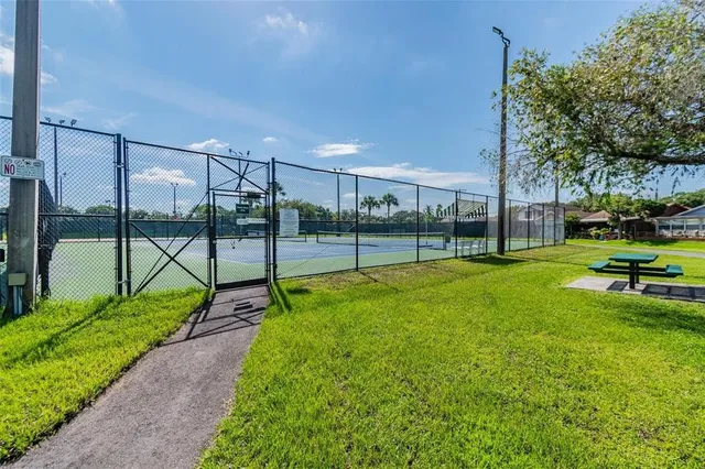 an aerial view of a pool yard and mountain view in back
