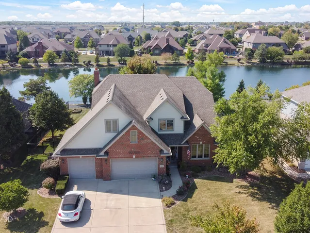 an aerial view of a house with garden space and lake view