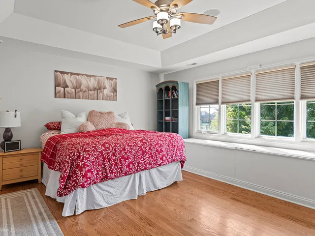 a bedroom with a large bed and a large window