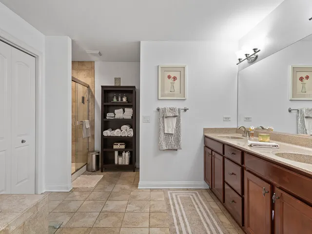 a spacious bathroom with a double vanity sink and a mirror