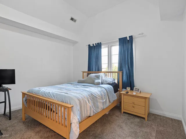 a bed room with a bed and a window