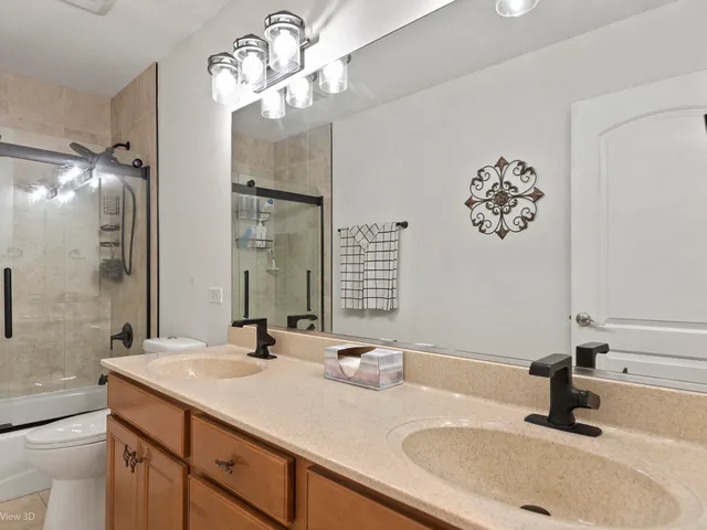 a bathroom with a sink double vanity and a mirror