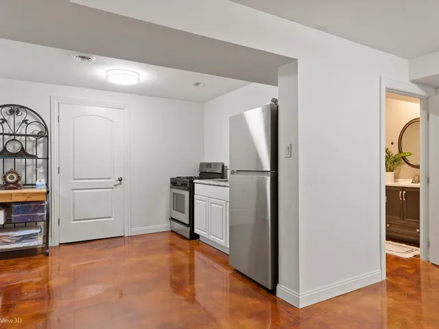 a view of a kitchen with refrigerator and cabinet
