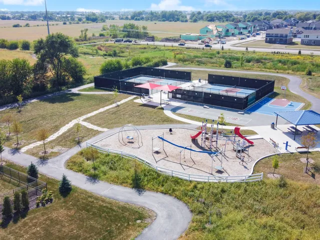 an aerial view of a house with a yard basket ball court and outdoor seating
