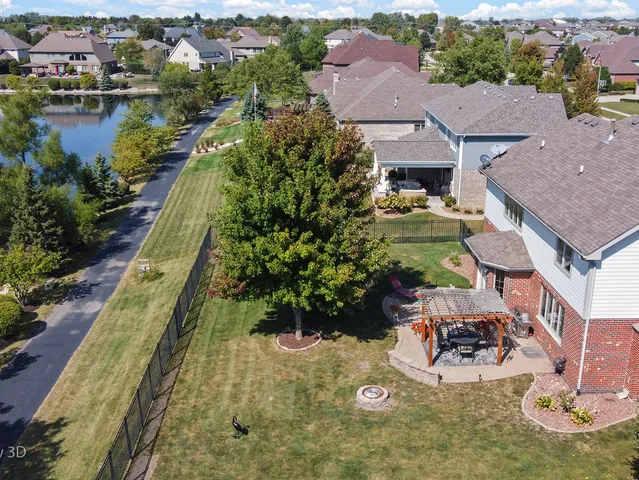 an aerial view of a house with garden space and lake view