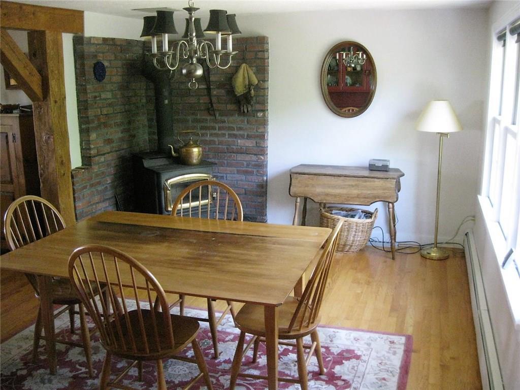 586 Mills Road Whitefield, ME 04353 - Photo 7 of 35 Dining Room with wood stove and hearth