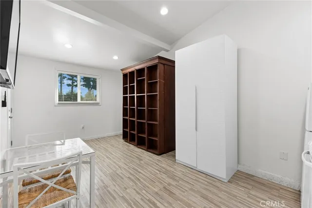 an empty room with a cabinet and a window