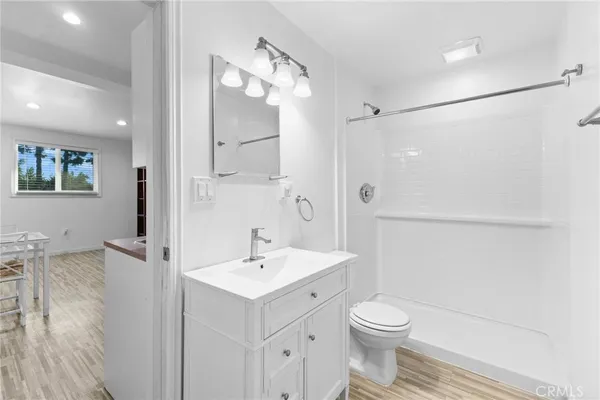 a bathroom with a sink a toilet and shower