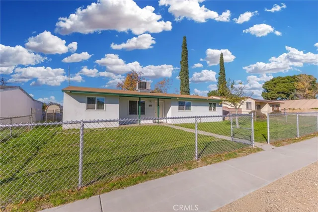 a view of a house with a backyard and a basket ball court