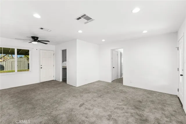 an empty room with windows and closet