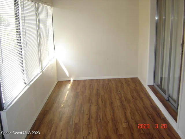 a view of hallway with wooden floor