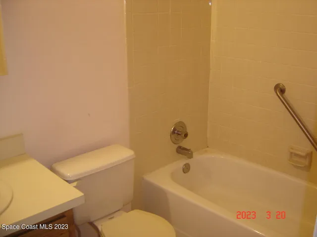 a white bath tub sitting next to a white toilet