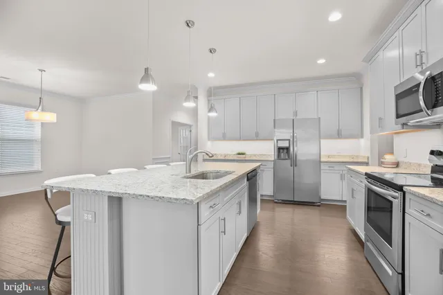 a kitchen with a sink stove cabinets and refrigerator