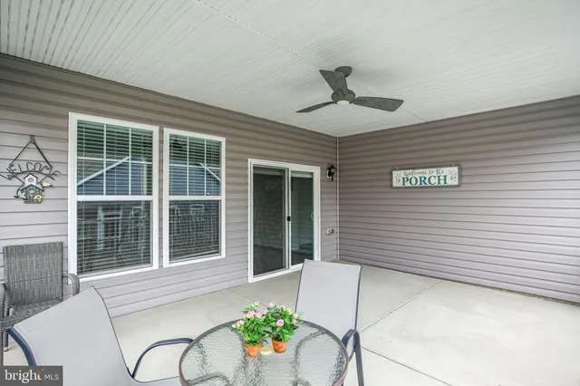 a view of a house with a chairs in patio