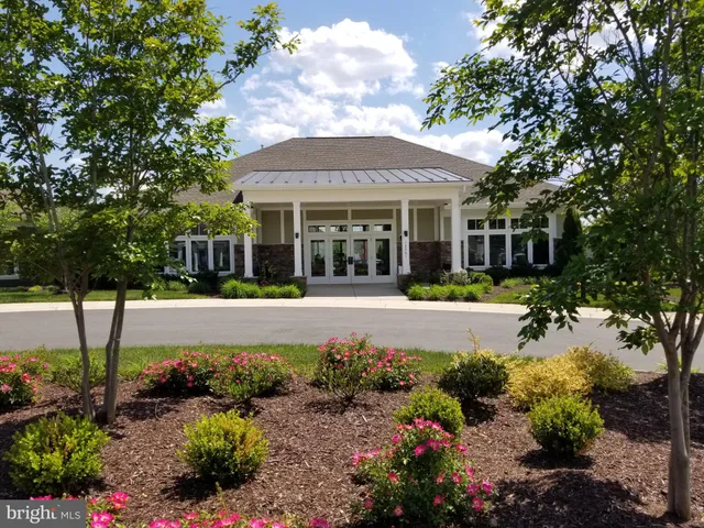 a living room with furniture gym equipment and a large window